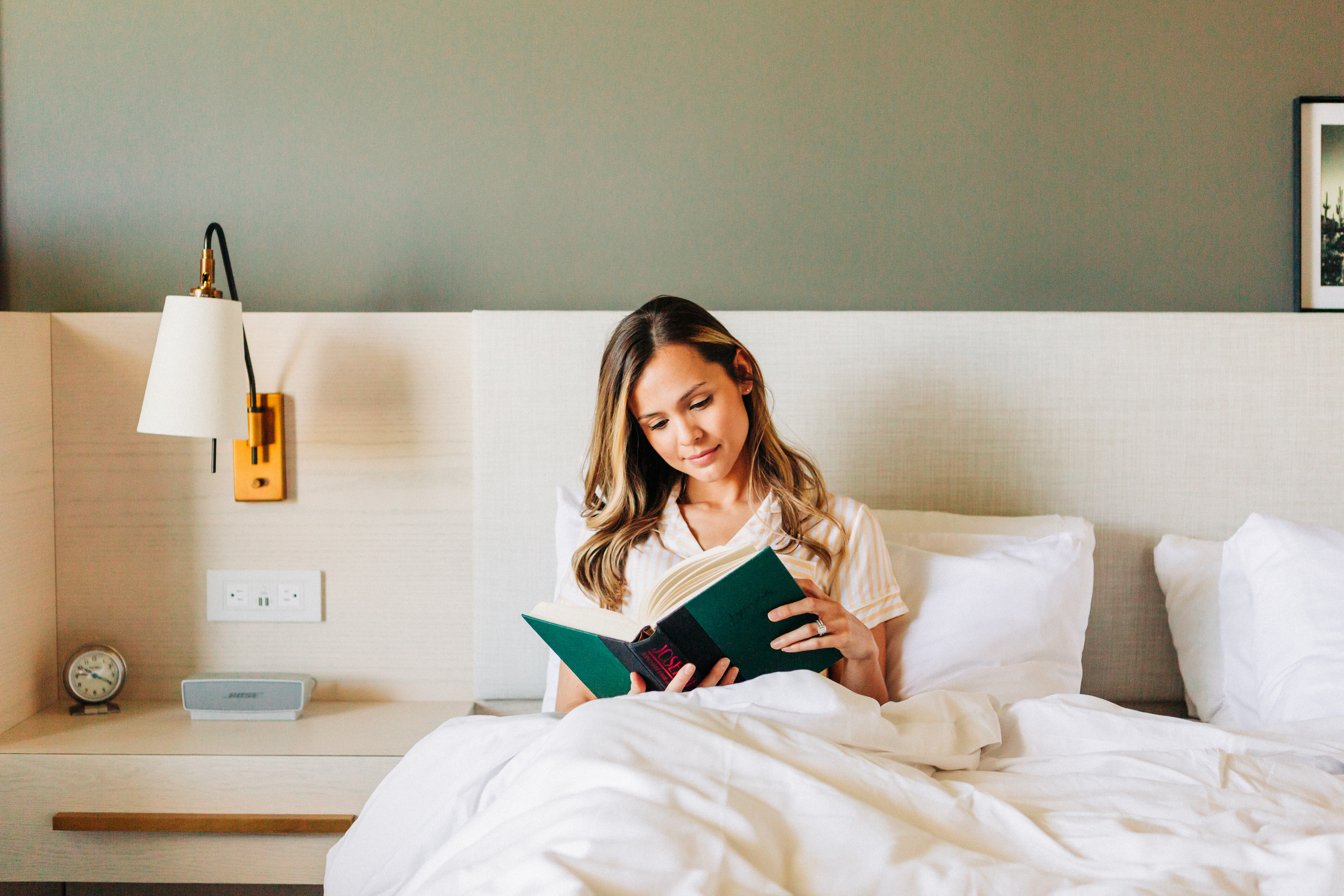 woman reading and learning in bed 